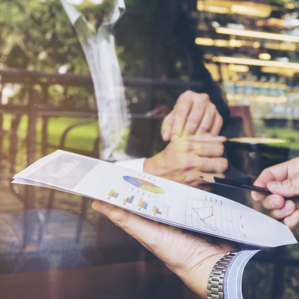 Two businessman discussing their report in coffee shop Two businessman discussing their report in coffee shop